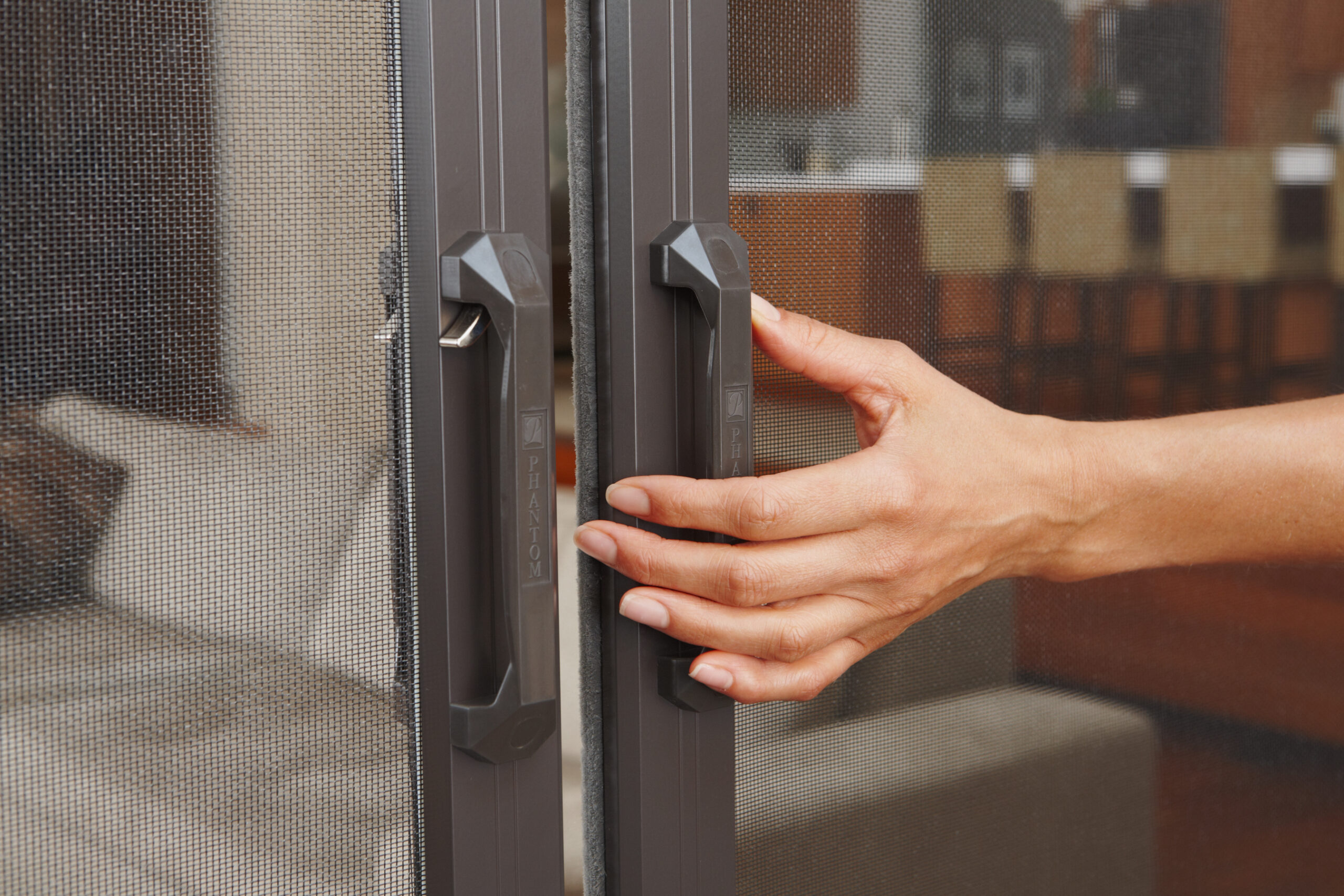 Phantom Screens latching handle system for retractable screen doors.