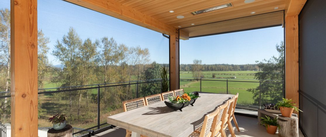 Large dining table on enclosed patio with retractable motorized screens