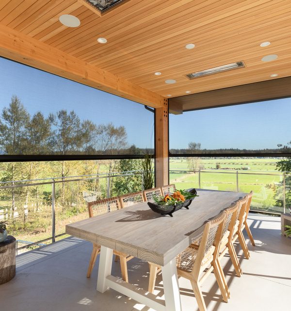 Large dining table on enclosed patio with retractable motorized screens