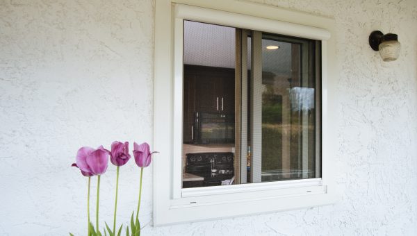 Close of home with retractable sliding window screens