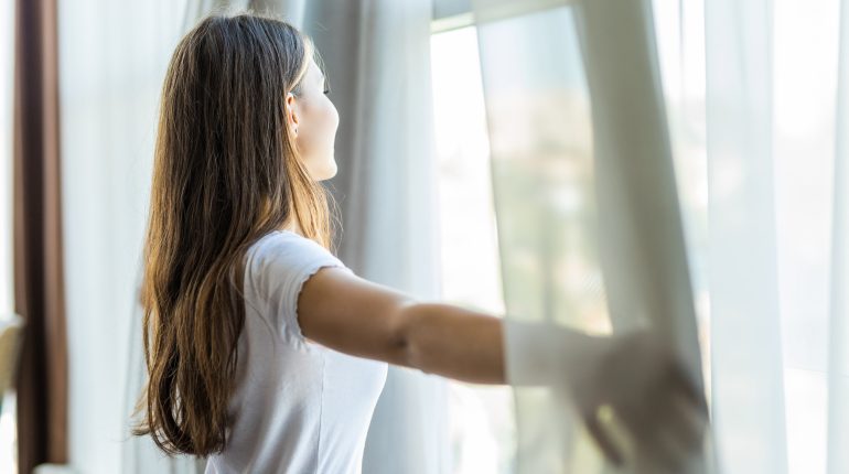 Woman looks out Windows