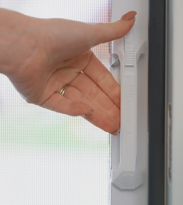 Woman locking retractable door screen