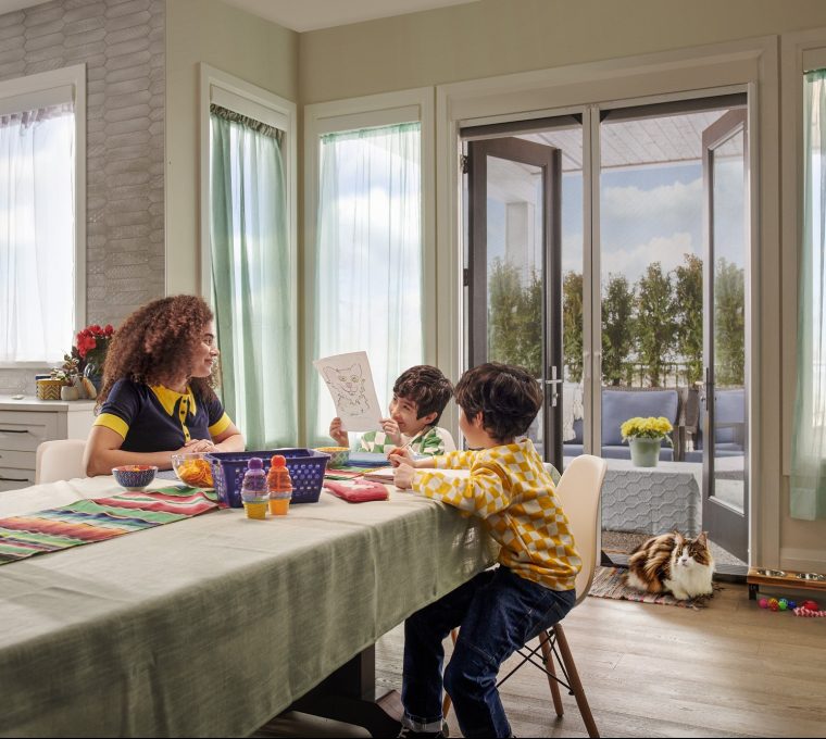 Family sitting at table with double doors with retractable door screens