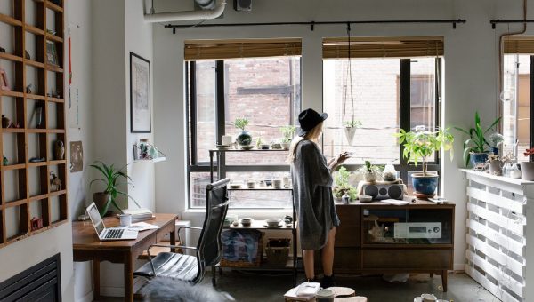 Woman standing in front of living room windows