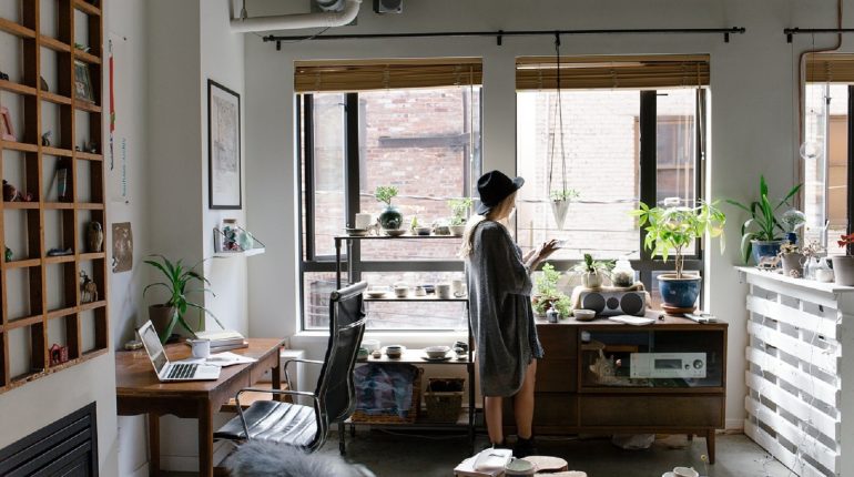 Woman standing in front of living room windows